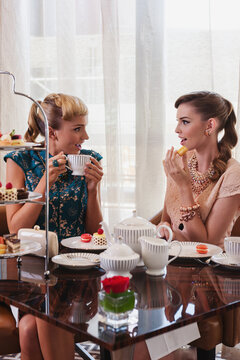 fashionable young women at a morning tea, gossiping