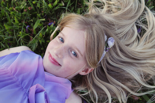 Pretty young girl lying on the grass
