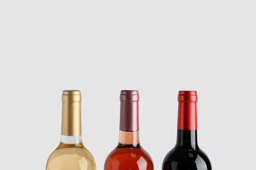 Bottles of wine on white background, closeup