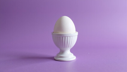 Single White Egg on Stand with Purple Background, World Egg Day Celebration, Bright, Clean, Sharp, Minimalist, High Resolution, Food Photography, Stock Image