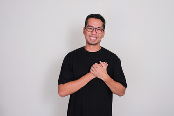 A man smiling happy with hands touching his chest