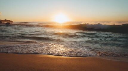 Beautiful beach scene with golden sand, crashing waves, sunset sky, blue clouds, and small wave rolling onto shore creating tranquil romantic atmosphere.