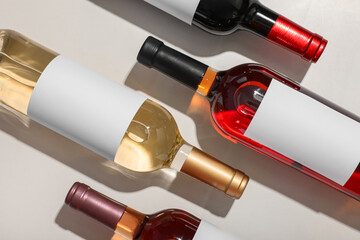 Bottles of different wine with blank labels on white background