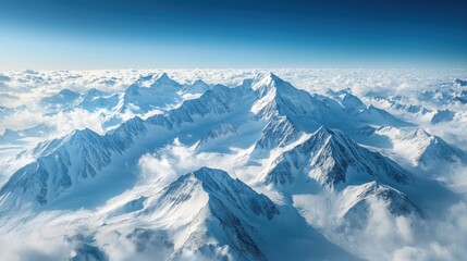 Aerial View of Snow Covered Mountain Peaks and Clouds