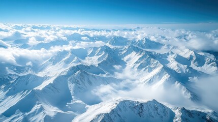 Aerial View of Snow Covered Mountain Range Under a Blue Sky