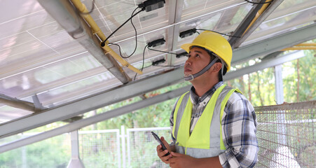 A technician inspects solar panels in a farming area to ensure optimal performance and sustainable energy use in agriculture. © 2D_Jungle