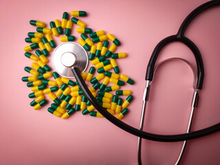 Top view statehoscope and medicine pill on a pink background