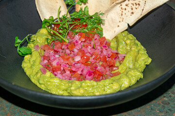 Guacamole with Nachos and Red Onion..