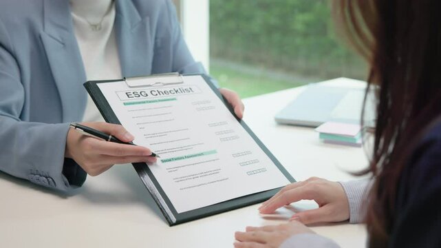 Asian female audit ESG risk check list paper form net zero waste supply chain vendor eco go green carbon credit control. Asia people woman give advice report prepare work review best practice process.