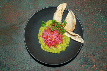 Guacamole with Nachos and Red Onion..