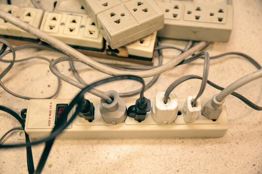 Old electrical extension cords plug is broken case damage and danger or connector voltage power burnt overload