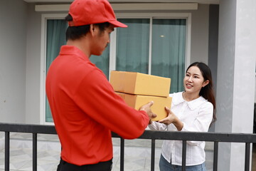 A woman receives a package at her doorstep from a delivery man. The moment captures online...