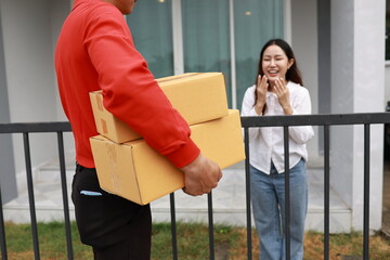 A woman receives a package at her doorstep from a delivery man. The moment captures online...