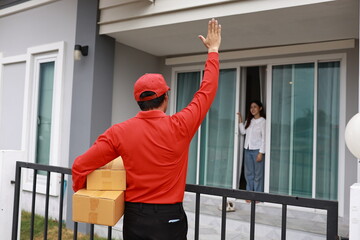 A woman receives a package at her doorstep from a delivery man. The moment captures online...