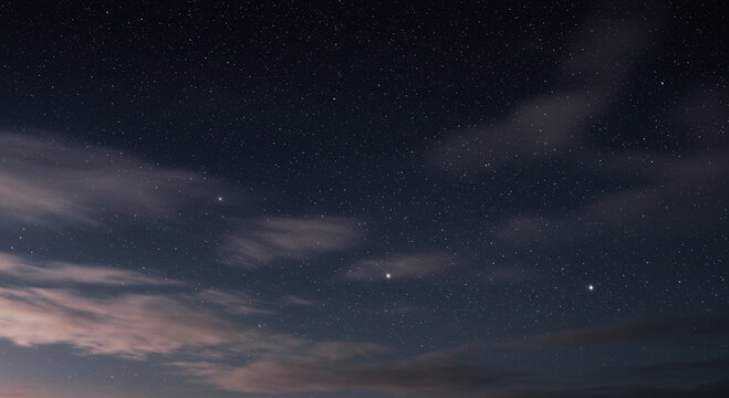 Celestial canvas of a starlit night sky with ethereal clouds