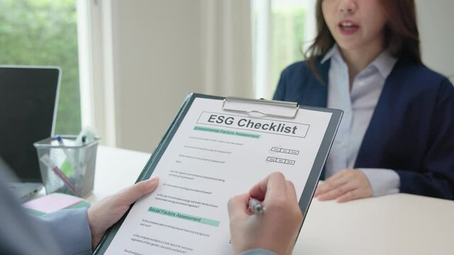 Asian female audit ESG risk check list paper form net zero waste supply chain vendor eco go green carbon credit control. Asia people woman give advice report prepare work review best practice process.