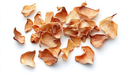 A scattering of dried, pale orange flower petals against a stark white background