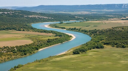 Fototapeta premium Aerial View of a Winding River Through Lush Green Landscape