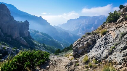 Naklejka premium Majestic Mountain Valley View With Blue Sky Sunlight And Lush Green Vegetation