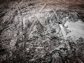 top view of muddy dirt road surface	