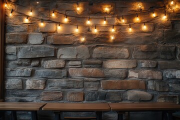 Naklejka premium Stone wall and wood tables with string lights background. Perfect for rustic, food or bar related ads.