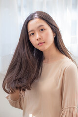 Portrait of smiling beautiful sexy long hair women in cozy room