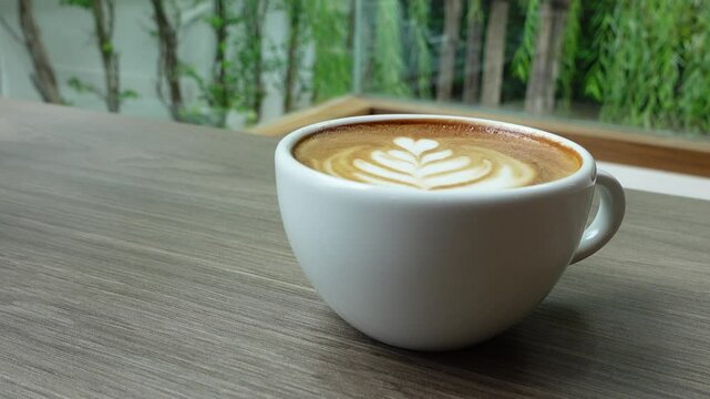 Barista Pouring Latte Art &ndash; Creating Rosetta Pattern in Cappuccino Cup, forming a beautiful latte art design. Ideal for coffee ads, tutorials, and aesthetic visuals.
