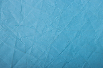 Abstract wrinkled blue crumpled paper texture background