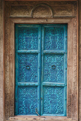 Antique Hand-Carved Wooden Door with ornate blue floral design.  The traditional hand-carved wooden...
