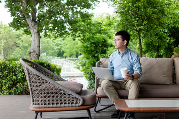 asian businessman working on smart phone outdoor