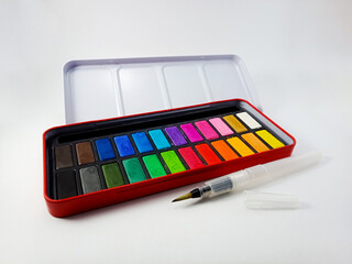 a water brush with watercolor paint on white background