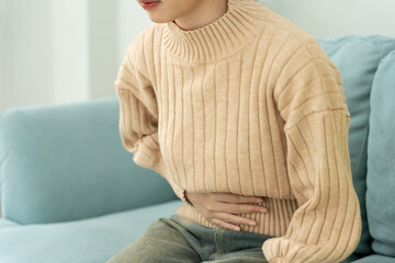 stomach ache. Asian women have abdominal pain, indigestion, gastritis, menstrual cramps,...