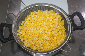 Finish boiling the corn kernels. drain the boiled corn kernels