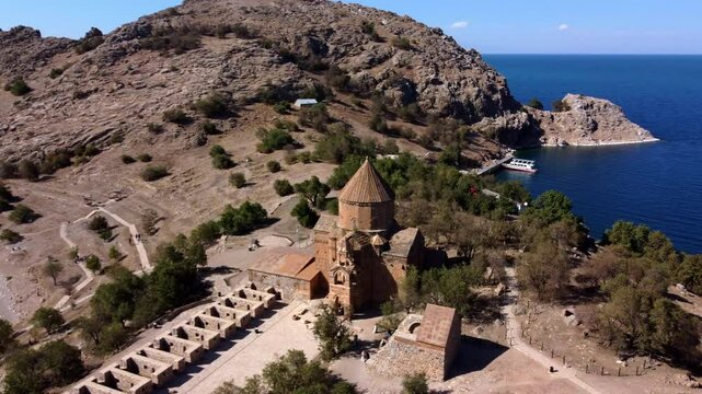 Aerial Panning Shot Of Akdamar Kilisesi Cathedral On Island In Rippled Lake During Sunny Day - Afyonkarahisar, T�rkiye