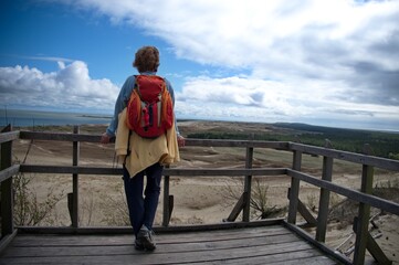 Rear view of mature woman standing on the beach in Lithuania