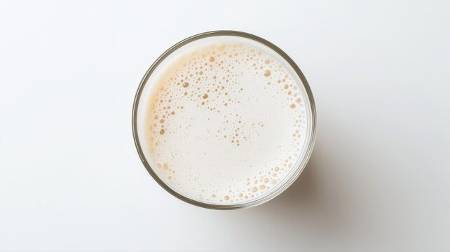 Top View of Foamy Drink in Glass on White Background drink glass foamy beverage foam bubbles frothy