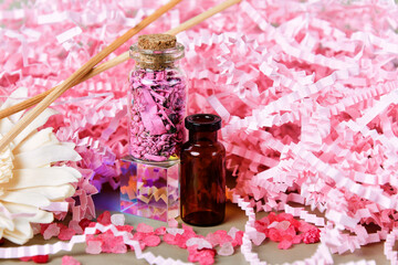 Delicate glass bottles, pastel-colored paper confetti
