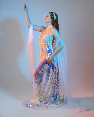 Fantasy studio portrait of a red-haired mermaid faery model wearing a white pearl gown, fairytale...