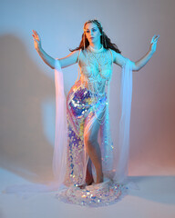 Fantasy studio portrait of a red-haired mermaid faery model wearing a white pearl gown, fairytale...