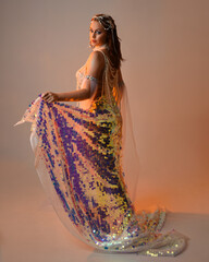 Fantasy studio portrait of a red-haired mermaid faery model wearing a white pearl gown, fairytale...