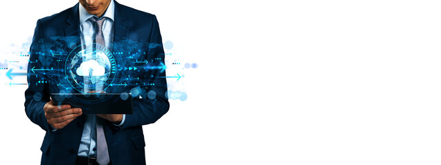 Businessman holding tablet with glowing cloud icon and digital interface, futuristic tech layout on...