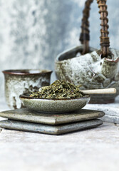 Dried Green Tea Leaves on Bright Background. Close up.	
