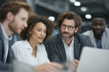 Diverse team collaboration in modern office setting with focused professionals