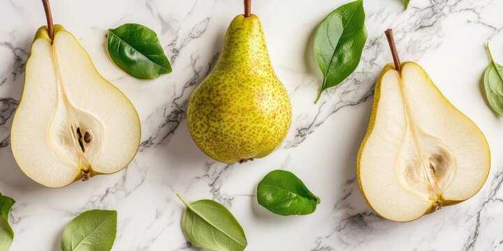 Two halves of a pear, a healthy fruit, on a marble surface.