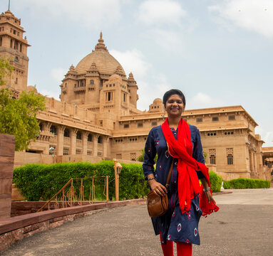 Woman tourist in front of Umaid Bhawan palace, Jodhpur, India
