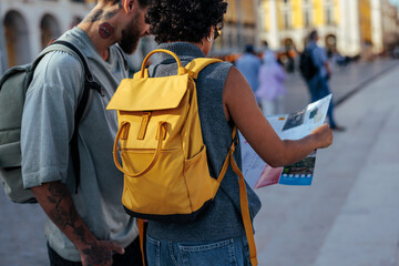 Tourists consulting map in a city square