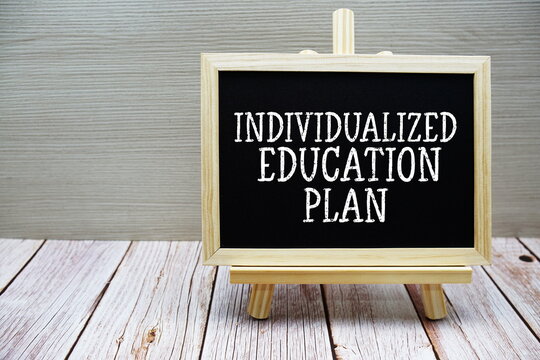 Individualized Education Plan text written on chalkboard with easel on wooden background
