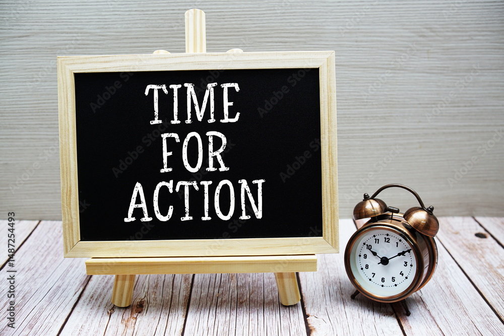 Poster time for action text written on chalkboard with alarm clock on wooden background