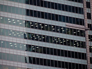 Obraz premium Modern Corporate Office Building with Glass Facade Reflecting Neighboring Buildings