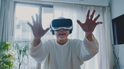 Asian old senior wearing vr headset feeling excited with metaverse. Retirement and senior lifestyle at home